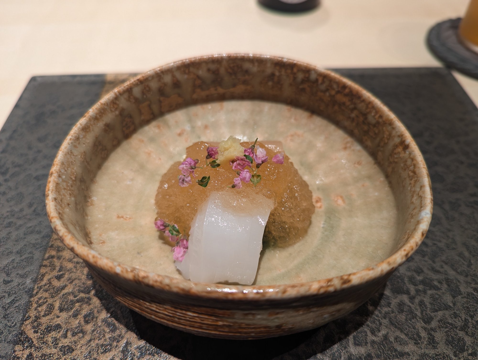 Kuchi-gaeshi. Sordam shiraae on a warm Densaku-gama vessel with pink flowers scattered across it