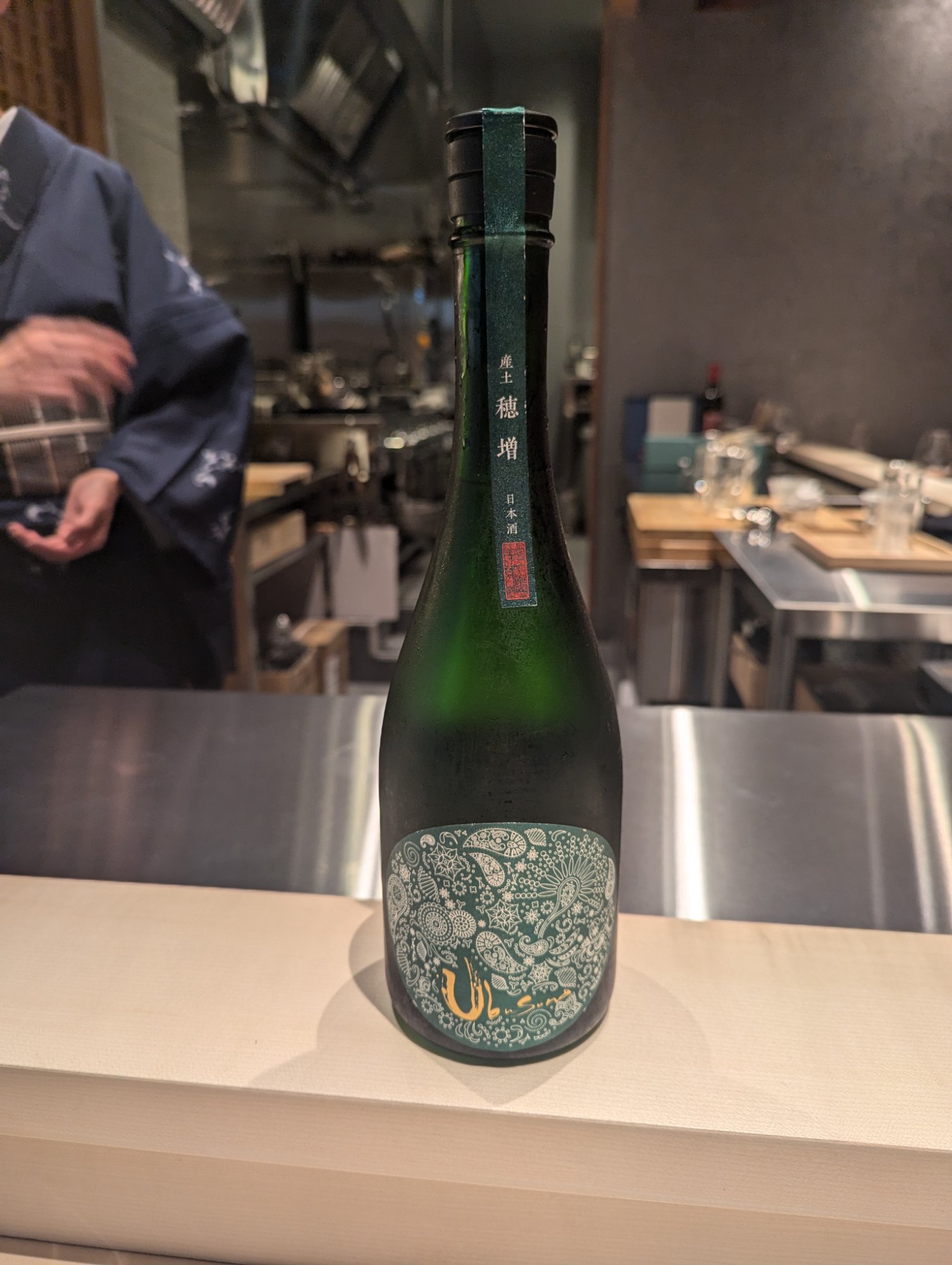 Ubusuna Homase. A deep green bottle with a paisley label resting quietly on the counter