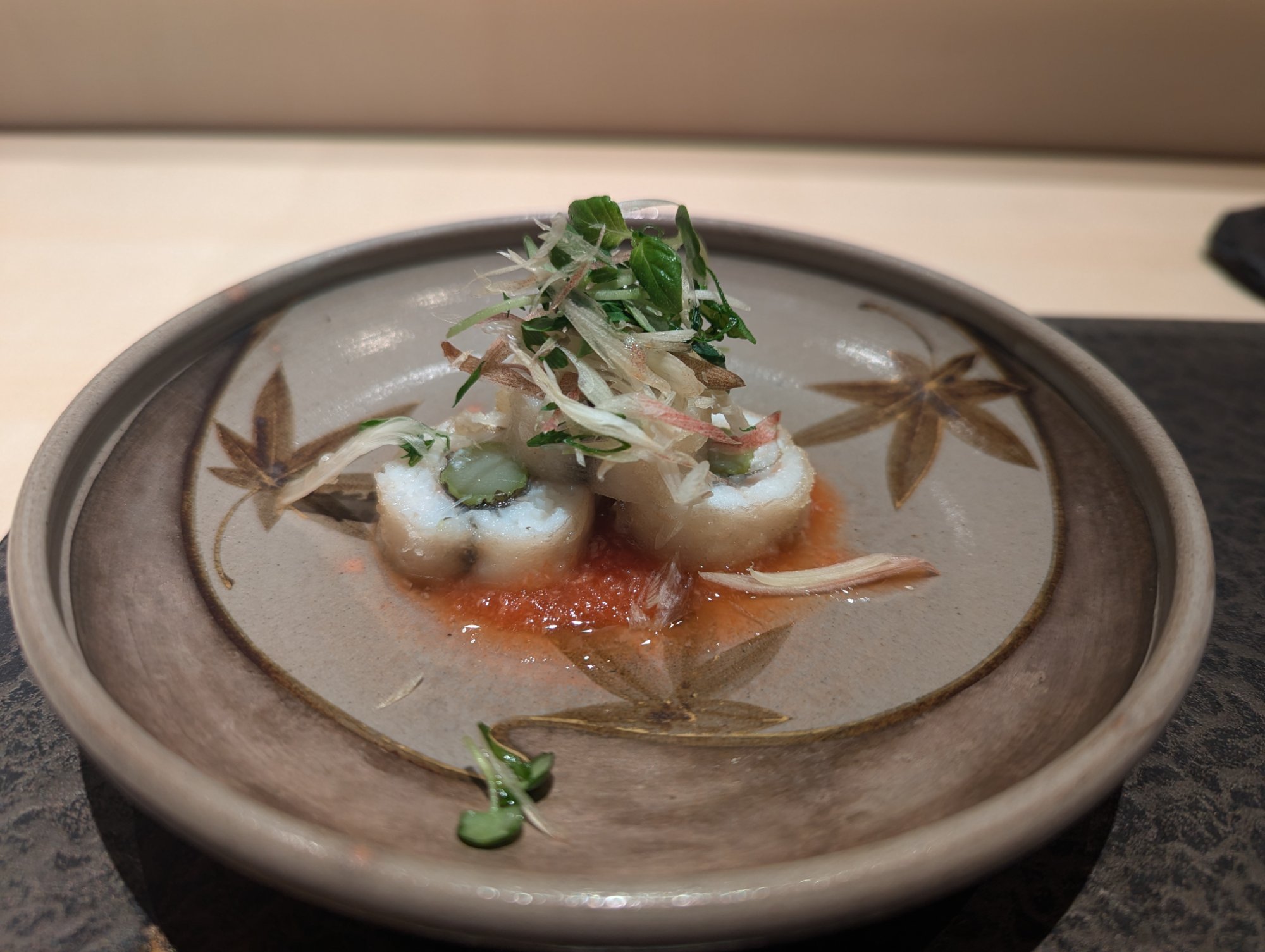 Agemono. Hamo on a maple-leaf patterned vessel with red cocktail sauce