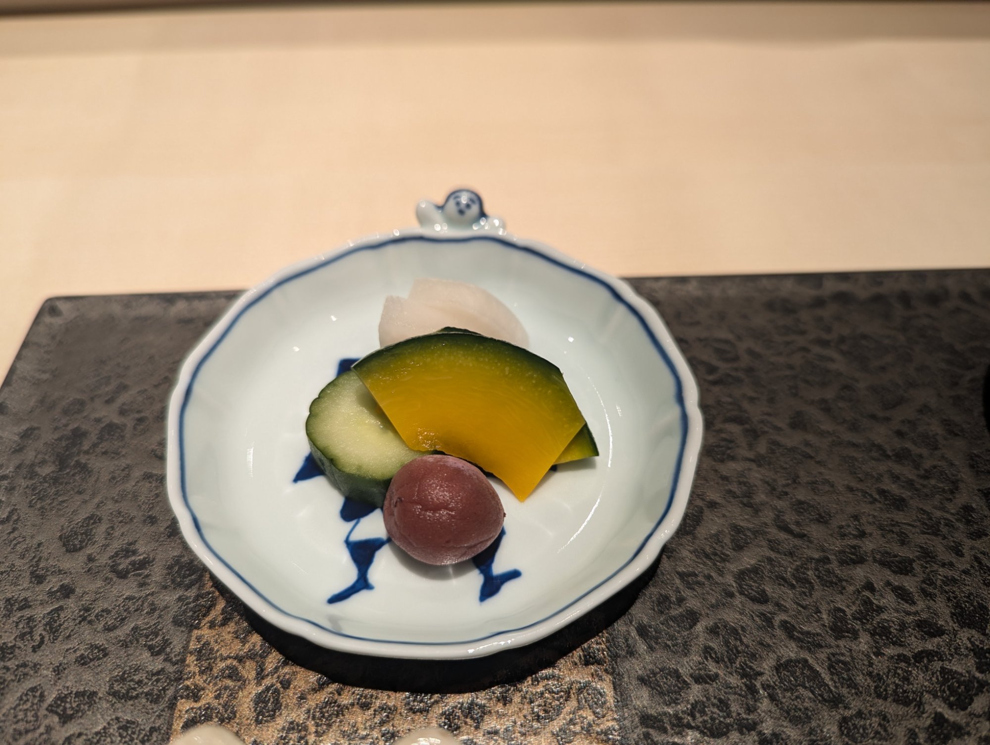Pickles on a blue-painted small plate, summer vegetables in vivid color