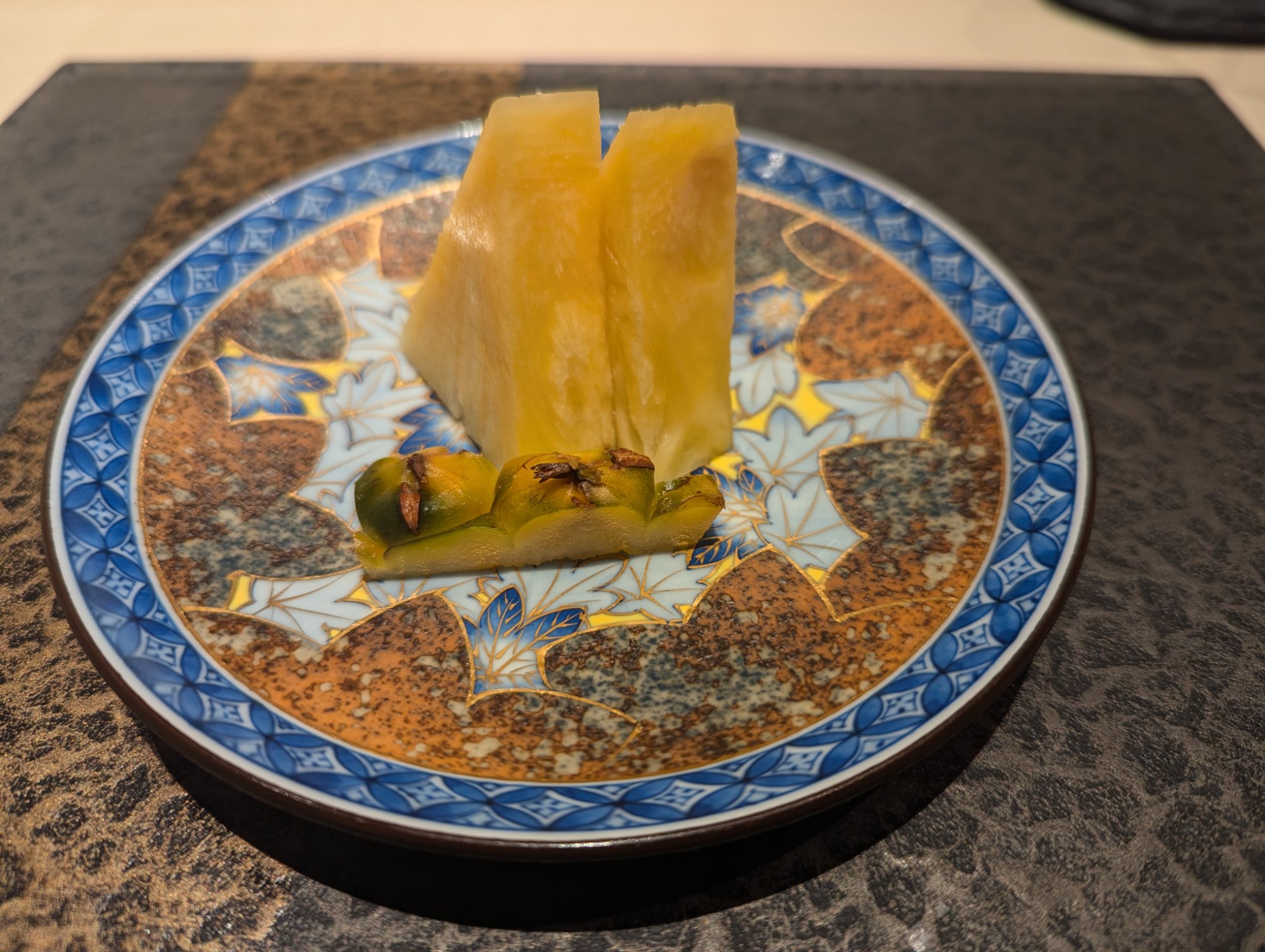 Dessert. Tadao Gold pineapple on an Imari-style plate, the slices arranged vertically like sails